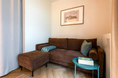 a living room with a brown couch and a table at WLB Apartments Comfort in Kraków
