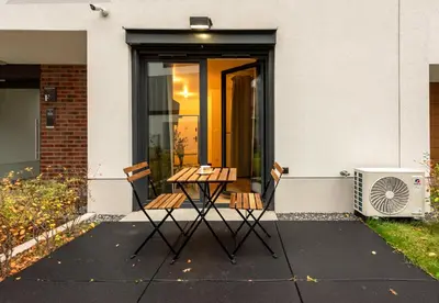 a table and chairs in front of a house at WLB Apartments Comfort in Kraków