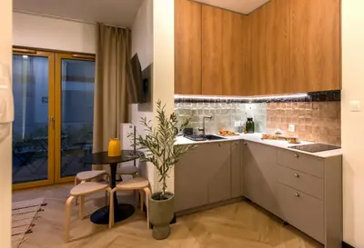 a kitchen with a table and chairs in a room at WLB Apartments Comfort in Kraków
