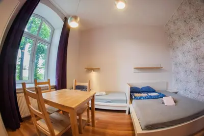 a room with a table and a dining room at Atlantis Hostel in Kraków