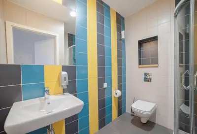 a bathroom with a sink and a toilet at Atlantis Hostel in Kraków