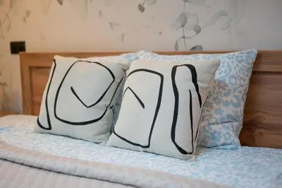 two pillows sitting on top of a bed at Apartament Solny Loretańska in Kraków