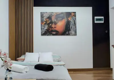 a bedroom with two beds and a painting on the wall at Apartament w centrum starego Krakowa in Kraków