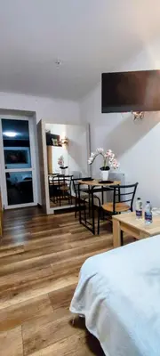a room with a bed and a table and chairs at Apartament w centrum starego Krakowa in Kraków