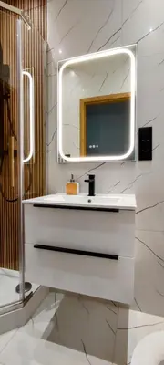 a bathroom with a white sink and a mirror at Apartament w centrum starego Krakowa in Kraków