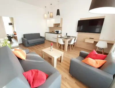 a living room with two blue couches and a table at Old Town Apartments - Bosacka B18 in Kraków