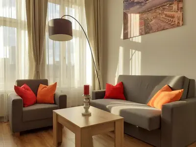 a living room with two couches and a table at Old Town Apartments - Bosacka B18 in Kraków