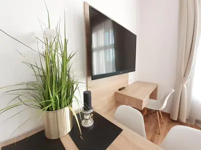 a living room with a table with a tv and a table sidx sidx at Old Town Apartments - Bosacka B18 in Kraków