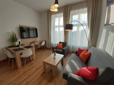 a living room with a couch and a table at Old Town Apartments - Bosacka B18 in Kraków