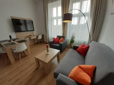 a living room with a couch and a table at Old Town Apartments - Bosacka B18 in Kraków