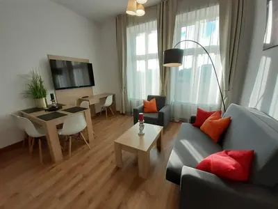 a living room with a couch and a table at Old Town Apartments - Bosacka B18 in Kraków