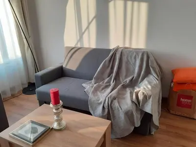 a living room with a couch and a table with a red candle at Old Town Apartments - Bosacka B18 in Kraków
