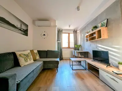 a living room with a green couch and a table at Królowej Jadwigi 9 by Homeprime in Kraków