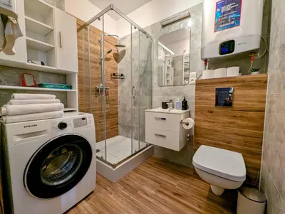 a bathroom with a washing machine and a shower at Królowej Jadwigi 9 by Homeprime in Kraków