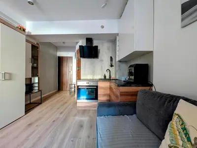 a living room with a couch and a kitchen at Królowej Jadwigi 9 by Homeprime in Kraków