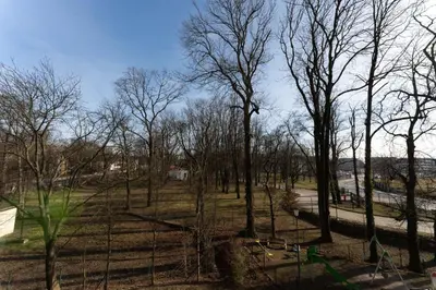 a park with some trees and a fence at Malila Premium Apartments Cracow Konopnickiej 63E in Kraków