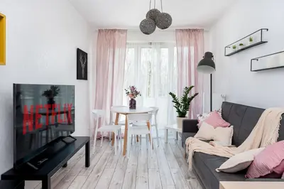 a living room with a couch and a table at Malila Premium Apartments Cracow Konopnickiej 63E in Kraków