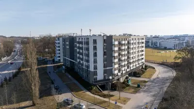 an apartment building in a city with a street at Malila Premium Apartments Cracow Konopnickiej 63E in Kraków