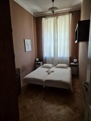 a small bedroom with a bed and a window at Enios Apartments ul Św Tomasza 33 in Kraków