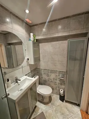 a bathroom with a toilet and a sink and a mirror at Enios Apartments ul Św Tomasza 33 in Kraków
