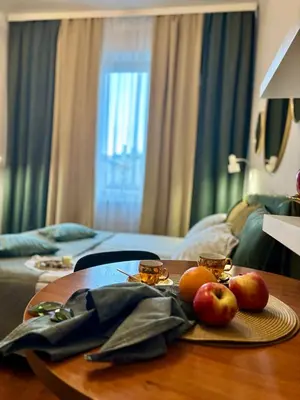 a table in a hotel room with fruit on it at Vintage Krowoderska Apartment in Kraków