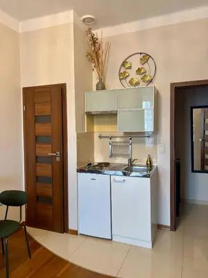 a kitchen with a sink and a counter top at Vintage Krowoderska Apartment in Kraków