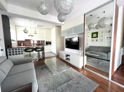 a living room with a couch and a television at Aspen Studio in Kraków