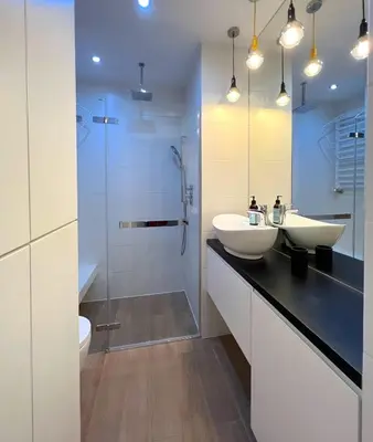 a bathroom with two sinks and a shower at Aspen Studio in Kraków