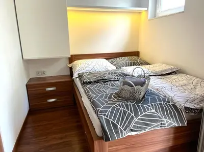 a bedroom with two beds with a basket on it at Aspen Studio in Kraków