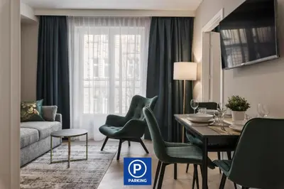 a living room with a table and chairs and a couch at Metropolis Apartments in Kraków