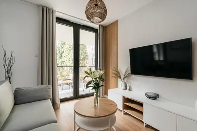 a living room with a tv and a couch and a table at Native Apartments Kościuszki 39I29 in Kraków