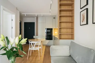 a kitchen and living room with a couch and a table at Native Apartments Kościuszki 39I29 in Kraków