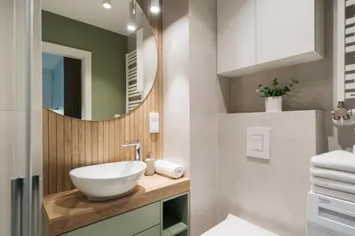 a bathroom with a sink and a mirror at Native Apartments Kościuszki 39I29 in Kraków