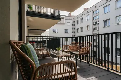 a balcony with chairs and tables on a building at Native Apartments Kościuszki 39I29 in Kraków