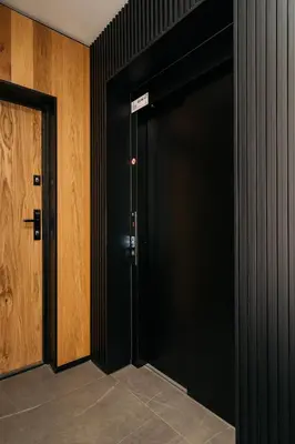 a black door with a sign on it in a room at Native Apartments Kościuszki 39I29 in Kraków