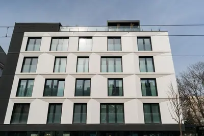 a white building with windows on top of it at Native Apartments Kościuszki 39I29 in Kraków