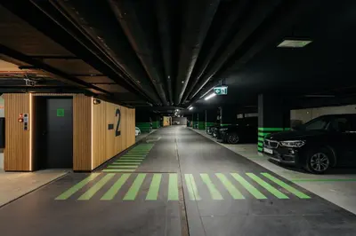 a parking lot with cars parked in a parking garage at Native Apartments Kościuszki 39I29 in Kraków