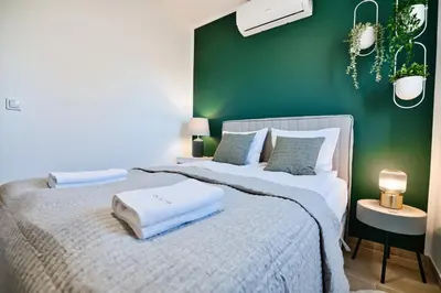 a green bedroom with a bed with towels on it at Green Vibe 11 Zator blisko Energylandii by Housine in Zator