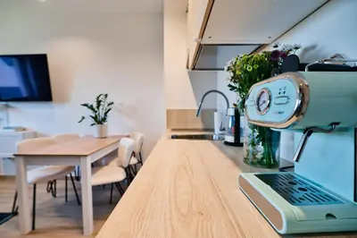 a kitchen and dining room with a table and a machine on a counter at Green Vibe 11 Zator blisko Energylandii by Housine in Zator