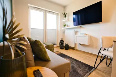 a living room with a couch and a tv at Green Vibe 11 Zator blisko Energylandii by Housine in Zator