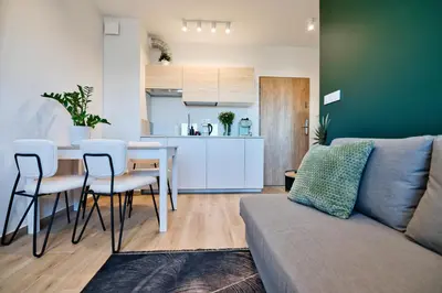 a living room with a couch and a table and a kitchen at Green Vibe 11 Zator blisko Energylandii by Housine in Zator