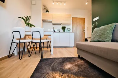 a kitchen and living room with a table and chairs at Green Vibe 11 Zator blisko Energylandii by Housine in Zator