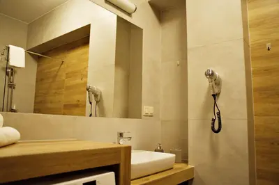 a bathroom with a phone on the wall next to a sink at Apartamenty Galicja Zator by Housine in Zator