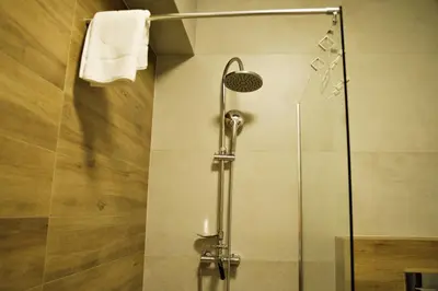 a shower with a glass door in a bathroom at Apartamenty Galicja Zator by Housine in Zator