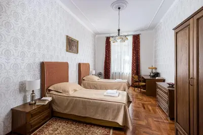 a bedroom with two beds and a dresser and a desk at Best location to explore Krakow Spacious 105m2 in Kraków