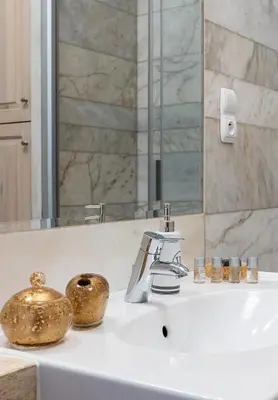 a bathroom sink with a mixer and a mirror at Best location to explore Krakow Spacious 105m2 in Kraków