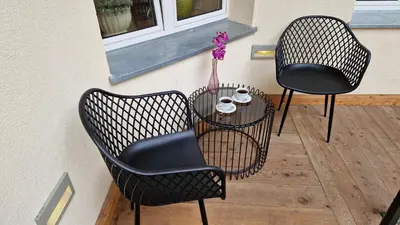 two chairs and a table on a patio at Best location to explore Krakow Spacious 105m2 in Kraków