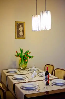 a table with plates and wine glasses on it at Best location to explore Krakow Spacious 105m2 in Kraków