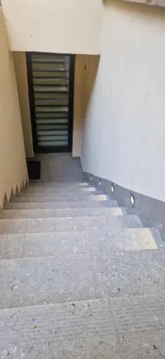 a hallway of a building with a door in the background at Marcel Apartment in Kraków