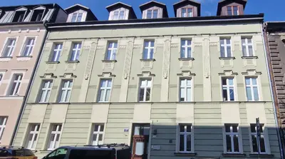 a large building with many windows on a street at Marcel Apartment in Kraków